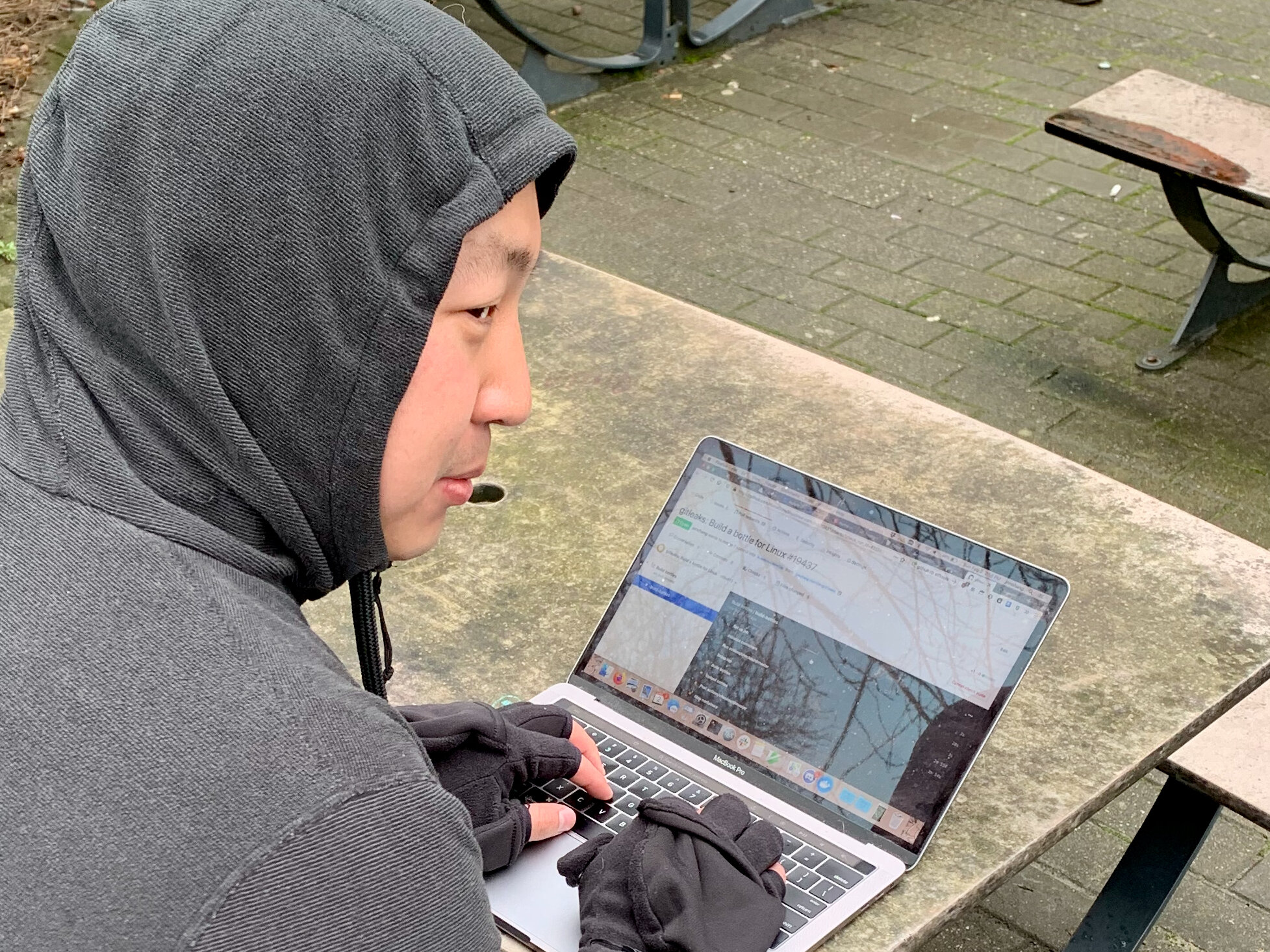 Jonathan hacking on continuous integration on his laptop outdoors in the cold.